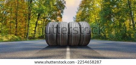 summer tires on the asphalt road in the sun - time for summer tires Royalty-Free Stock Photo #2254658287