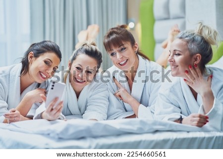 Girls at spa party in hotel with phone