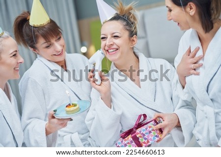 Picture of four girls in bathrobe having spa birthday party