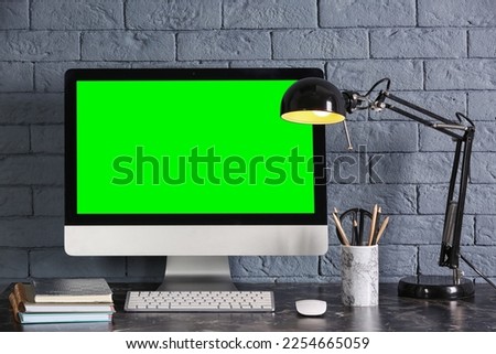 Computer display with chroma key on desk in room. Comfortable workplace