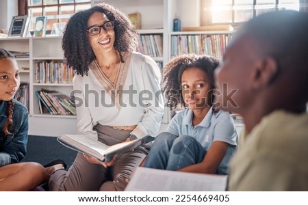 Storytelling, teacher or students with talking in a library asking questions for learning development. Education, kids or children listening to a black woman speaking on fun books at school classroom Royalty-Free Stock Photo #2254669405