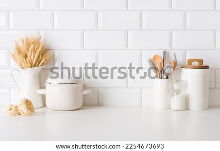 Cooking utensils and pasta on kitchen table with copy space Royalty-Free Stock Photo #2254673693