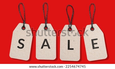 SALE word on cardboard price tag set isolated on red background. Sale sign
