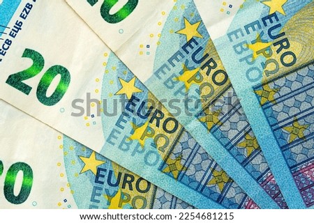 Blue banknotes of 20 euros beautifully laid out.European Union banking, financial savings.