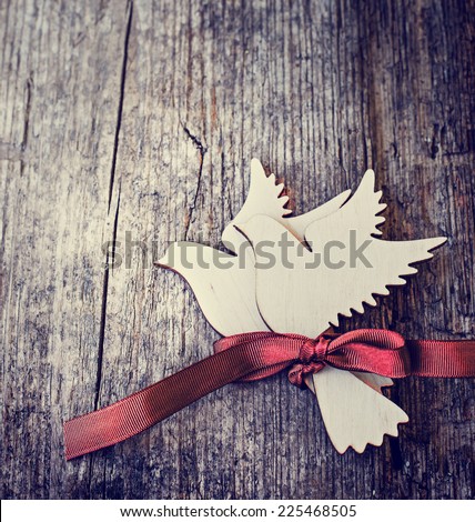 Two white birds with ribbon on wooden background. Romantic Card for Valentines day as a symbol of love