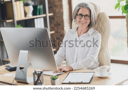 Photo of intelligent banker lady sitting leather chair keyboard write email loft interior office indoors