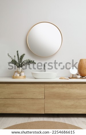 Modern bathroom interior with stylish mirror, eucalyptus branches and vessel sink Royalty-Free Stock Photo #2254686615