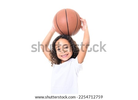 An Adorable black little girl with beautiful hairstyle have fun in sport clothes play basketball