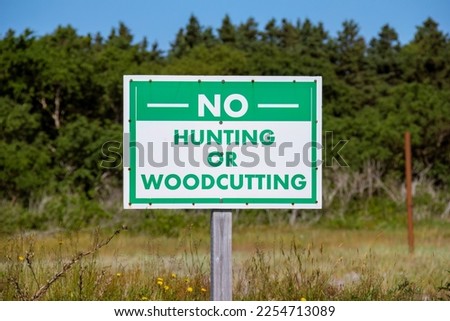 A no hunting or woodcutting sign
