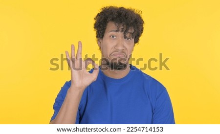 Casual African Man with Ok Sign on Yellow Background