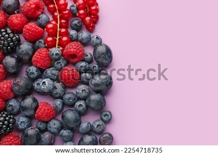 Heap of fresh ripe berries on color background Royalty-Free Stock Photo #2254718735