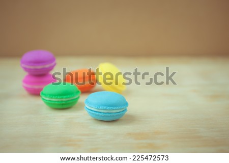 selective focus colorful french macaron on  wooden  background pastel color style.