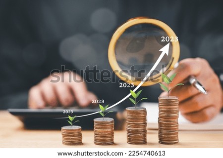 Money coin stack growing graph concept. Business finance and saving money investment, graph growing up on coin. Balance savings and investment. coin tower stacked on desk wooden, Closeup, copy space