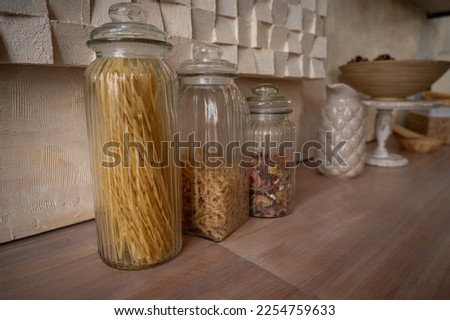 organization of food storage in the kitchen, transparent reusable jars for cereals and pasta, zero waste pantry