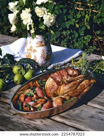 roasted chicken with bacon and sausages on wooden table in Provence