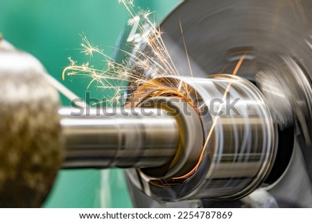 Grinding the hole on a cylindrical grinder with coolant. Royalty-Free Stock Photo #2254787869