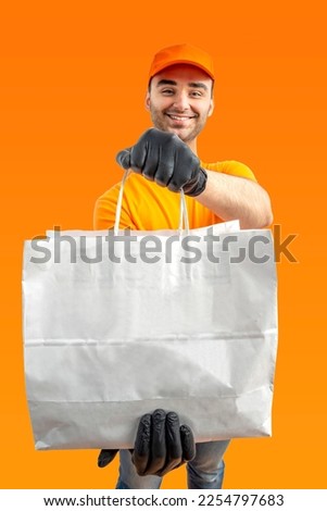 Delivery man with paper bag. Courier in uniform cap and t-shirt, gloves service fast delivering orders. Young guy holding a cardboard package. Character on isolated background for mockup design.