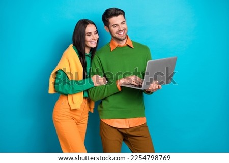 Photo of loving harmony couple using netbook watch romantic movie valentine day isolated on blue color background