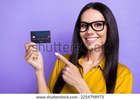 Photo of intelligent pretty lady banker wear trendy clothes presenting plastic debit card nfc function isolated on purple color background