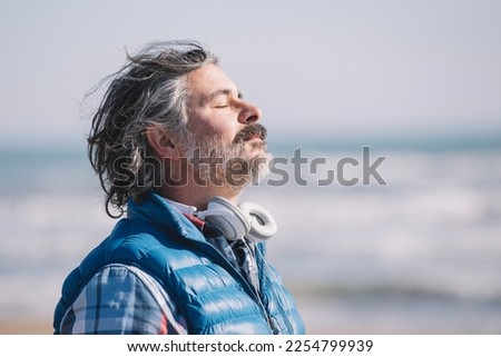 A man on the beach. relaxing deep breathing. Royalty-Free Stock Photo #2254799939