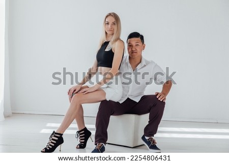 a pair of man and woman lovers embrace on a white background
