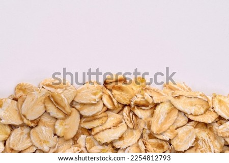 Macro photo of oatmeal on a white background,texture,background.Healthy, delicious food, source of amino acids,minerals, vitamins.Top view. Copy space.