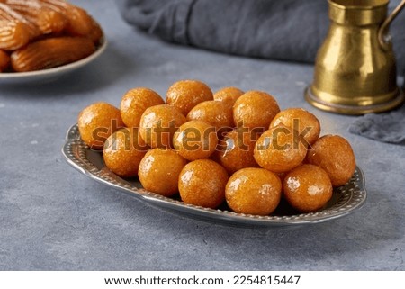 Traditional middle eastern fried sweets lokma, awameh, luqaimat. Ramadan dessert . Closeup Royalty-Free Stock Photo #2254815447