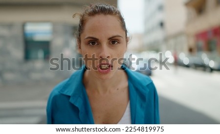 Young woman angry standing at street Royalty-Free Stock Photo #2254819975