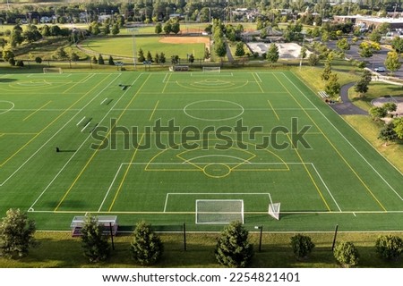 Aerial view of a sports complex with baseball and softball diamonds, artificial turf soccer and lacrosse field, a skate park and batting cages. Royalty-Free Stock Photo #2254821401