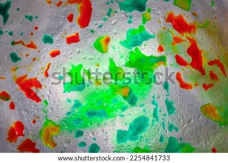 neon cosmic bright abstraction of water drops of different colors and different sizes of light green yellow orange red purple and blue rainbow colors