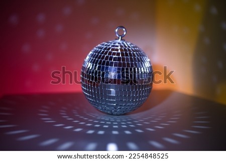 Disco ball close-up on neon background. Glow and flashes of light. Disco. Preparation for the party.