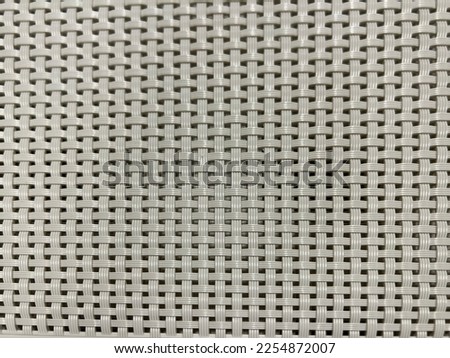 GRAY PLASTIC WEAVE TEXTURED BACKGROUND
