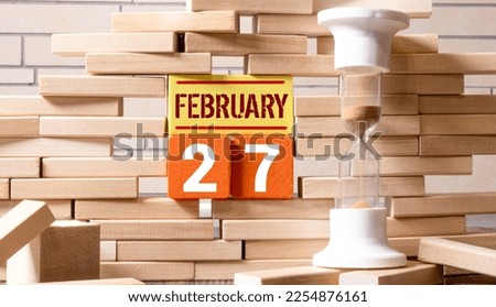 Cube shape calendar for February 27 on wooden surface with empty space for text,cube calendar for december on wood background.