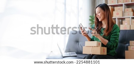 Portrait of Starting small businesses SME owners female entrepreneurs working on receipt box and check online orders to prepare to pack the boxes, sell to customers, SME business ideas online. Royalty-Free Stock Photo #2254881101
