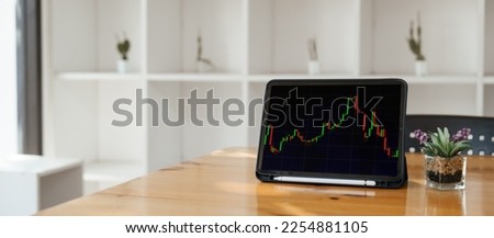 Screen of Tablet mockup on work desk. Office desk, business composition, Stock market news, invest online, drive statistical analysis.