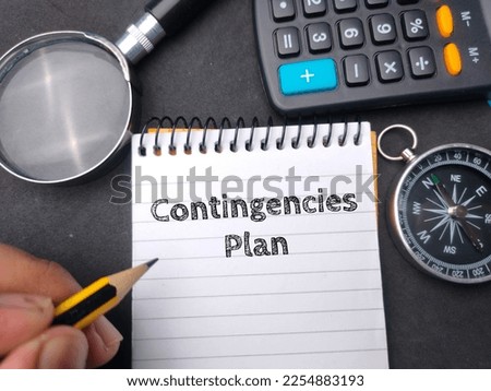 Hamd holding pencil wriiten on notebook with the word Contingencies Plan. Business concept. Royalty-Free Stock Photo #2254883193