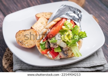 Gyro, Greek food served in a white plate Royalty-Free Stock Photo #2254904213