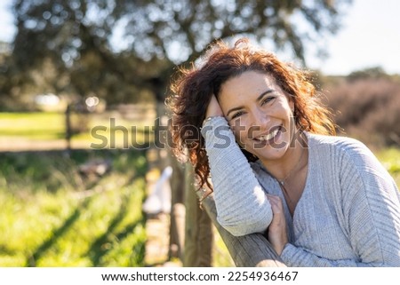 Happy Woman Smiling At Camera In A Field