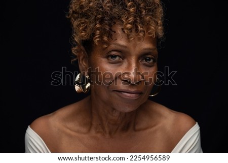 Beautiful elderly African American senior citizen widow looking at camera with neutral serious expression Royalty-Free Stock Photo #2254956589