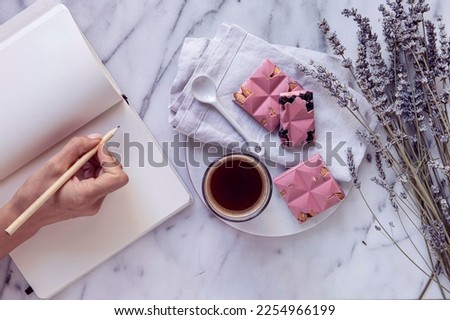 Christmas Planning. Woman writing plans for Xmas and drinking coffee 