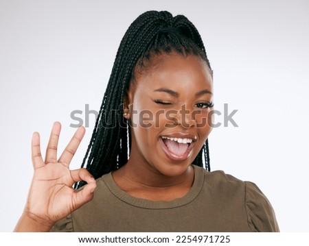Portrait, ok sign and black woman with smile, confident and achievement with girl on studio background. Face, African American female and happy lady with good news, celebration or success on backdrop