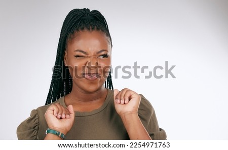 Silly, happy and black woman face with sassy emoji attitude facial expression in studio. White background, isolated and young model with fashion fashion with comic, crazy and goofy gesture alone Royalty-Free Stock Photo #2254971763