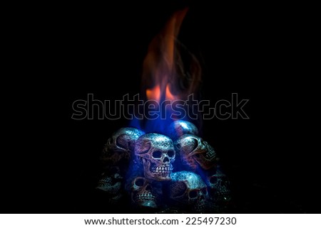 Burning skulls on black background