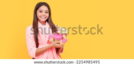 happy teen girl in home terry bathrobe with toy, happiness. Banner of child girl with toy, studio portrait, header with copy space. Royalty-Free Stock Photo #2254985495