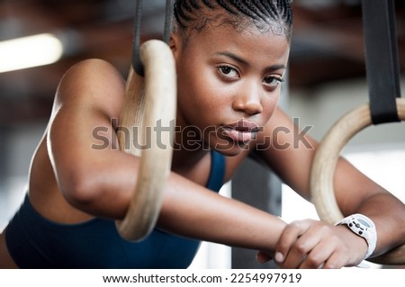Fitness, gymnastics and portrait of black woman with rings for training, exercise and workout at gym. Wellness, motivation and face of girl athlete with focus for competition, performance and sports