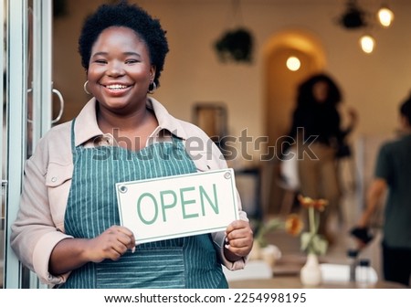 Open sign, portrait and black woman in small business startup for shopping, customer service and retail success. Boss, manager or person hand holding board for welcome in new store with smile at door