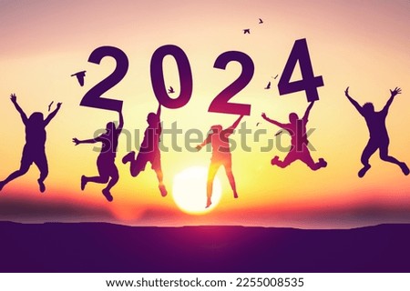 Silhouette friends jumping and holding number 2024 on sunset sky with birds flying abstract background at tropical beach. Happy new year and holiday celebration concept. Vintage tone color style.
