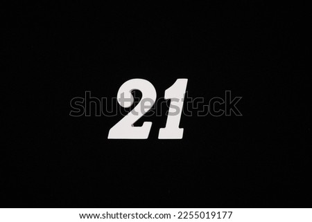 white numbers on a black background Made of wood sprayed with white spray paint.