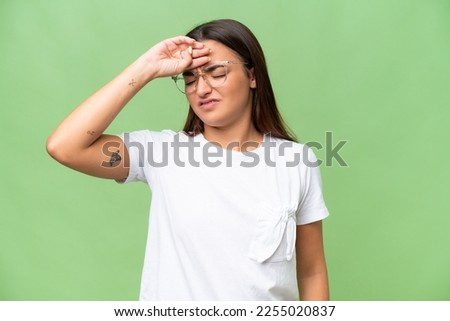 Young caucasian woman isolated on green chroma background with tired and sick expression