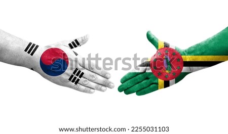 Handshake between South Korea and Dominica flags painted on hands, isolated transparent image.